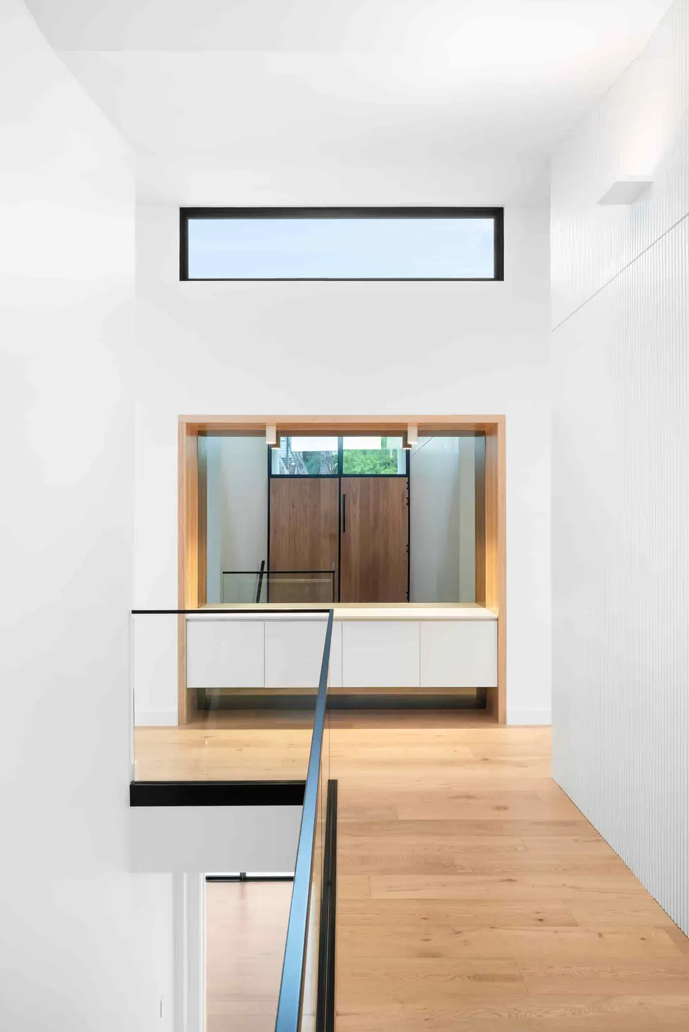 Upper level landing with oak flooring and timber entry door